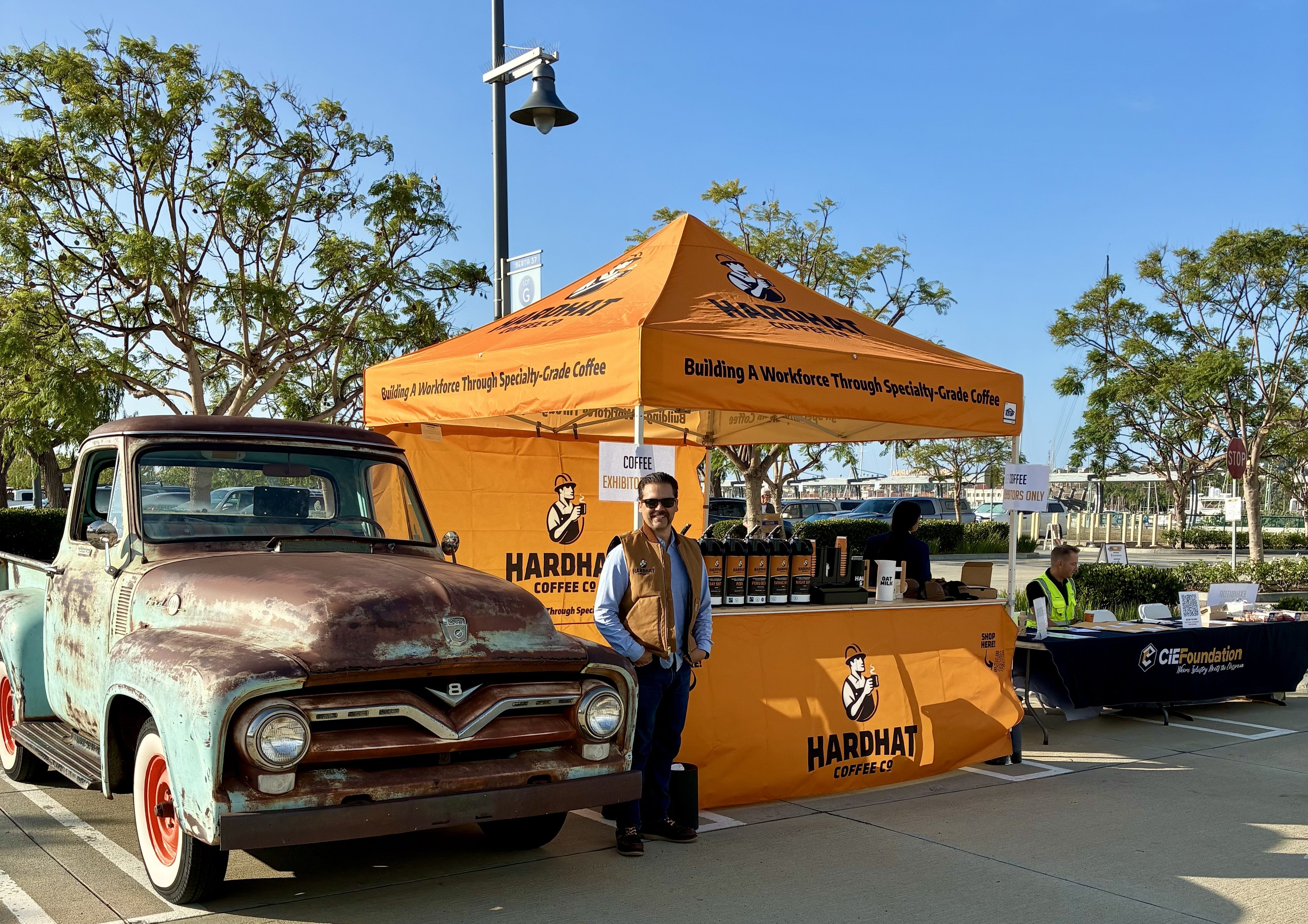 Cole Leslie with the Hardhat Coffee Co. booth and a vintage Ford pickup at CIEF Trades Day, Port of Los Angeles